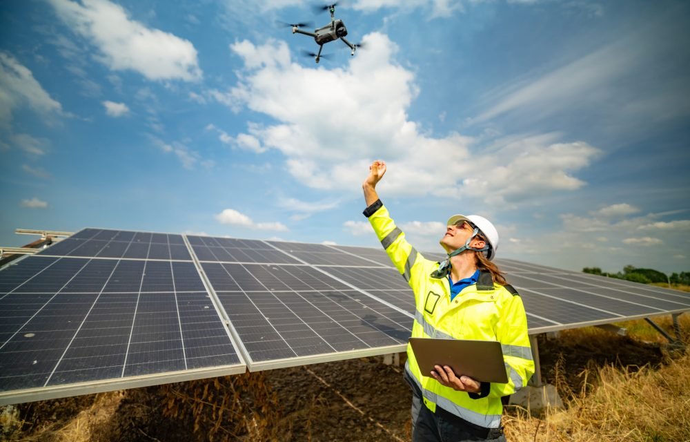 worker-with-drone-inspecting-solar-panels-on-sunny-2026-03-18-05-38-21-utc